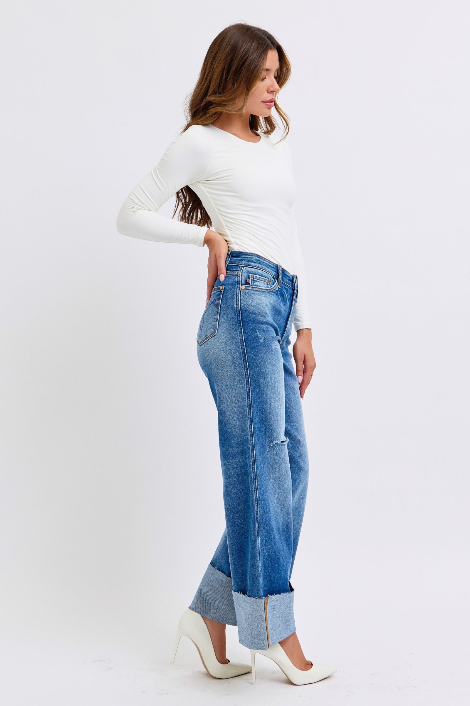 Model posing in Elysian Distressed Wide-Leg Denim jeans