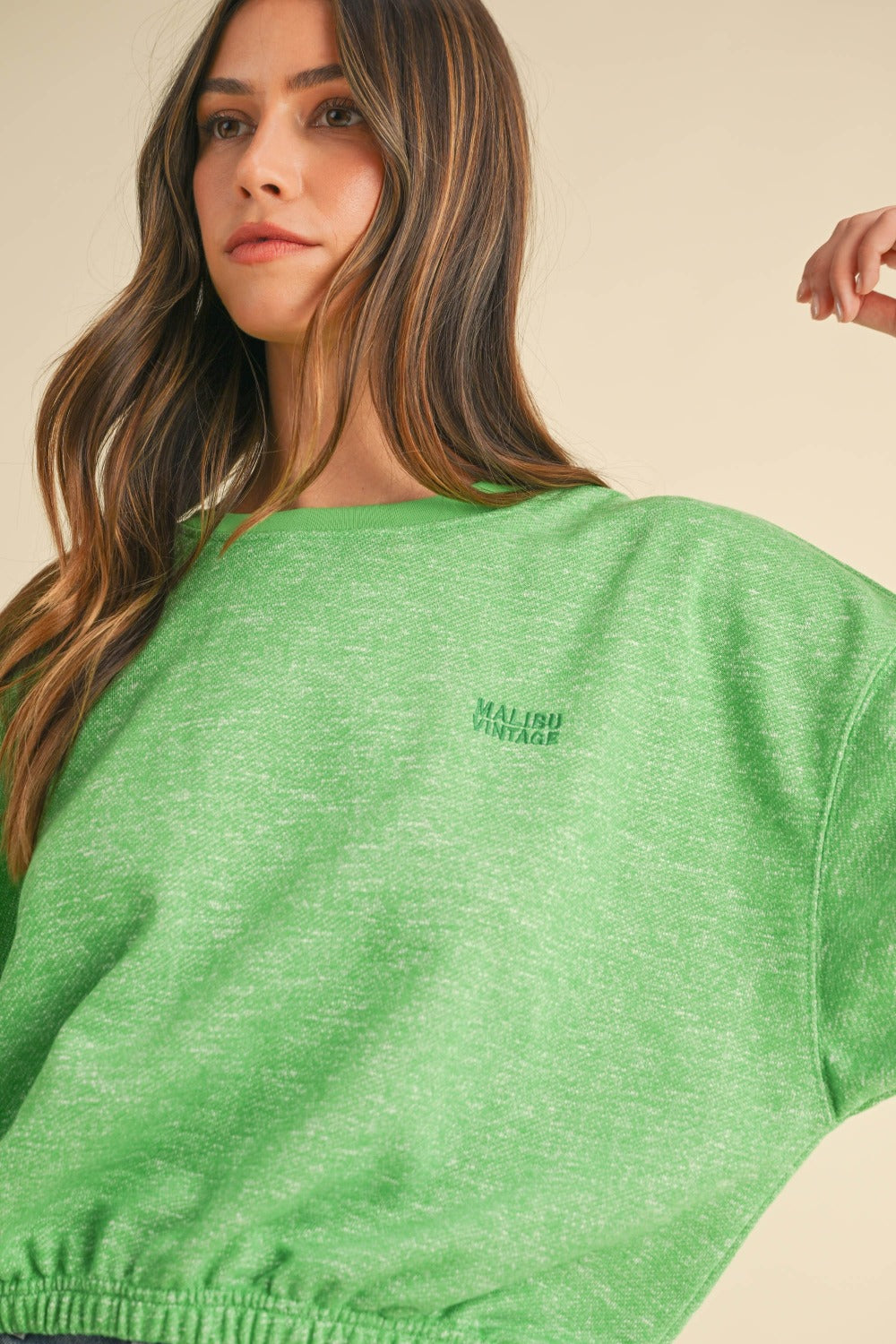 Close-up of green round neck letter embroidery crop sweatshirt