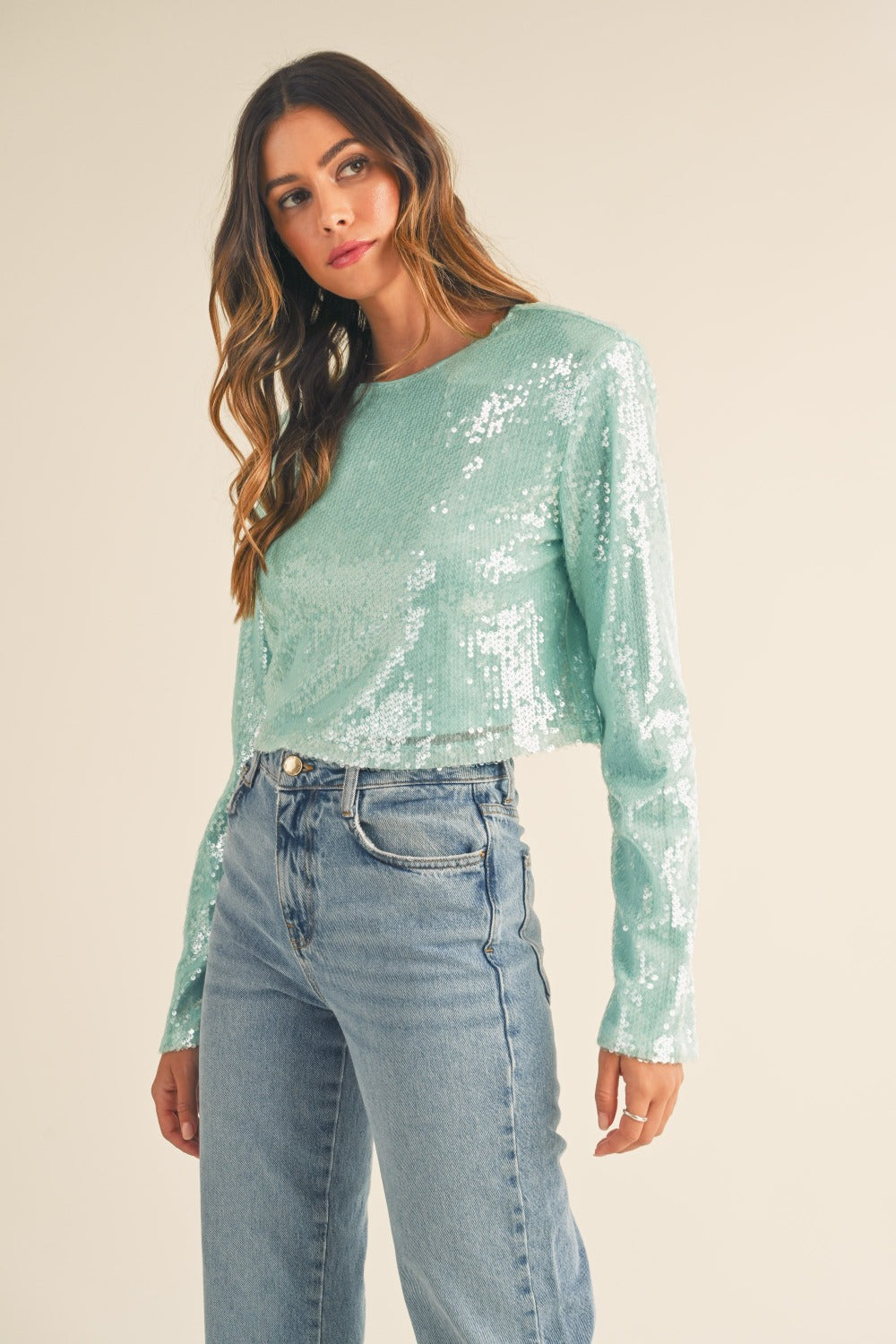 Green shoulder padded sequin crop top, angled front view