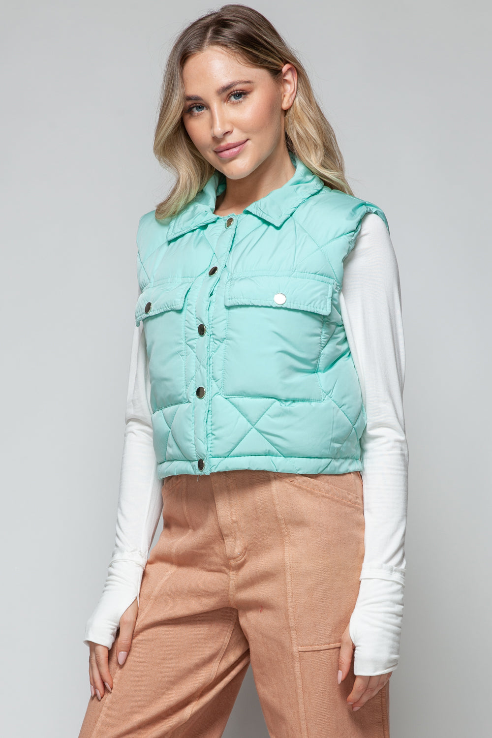 Front view of quilted crop vest with snap buttons