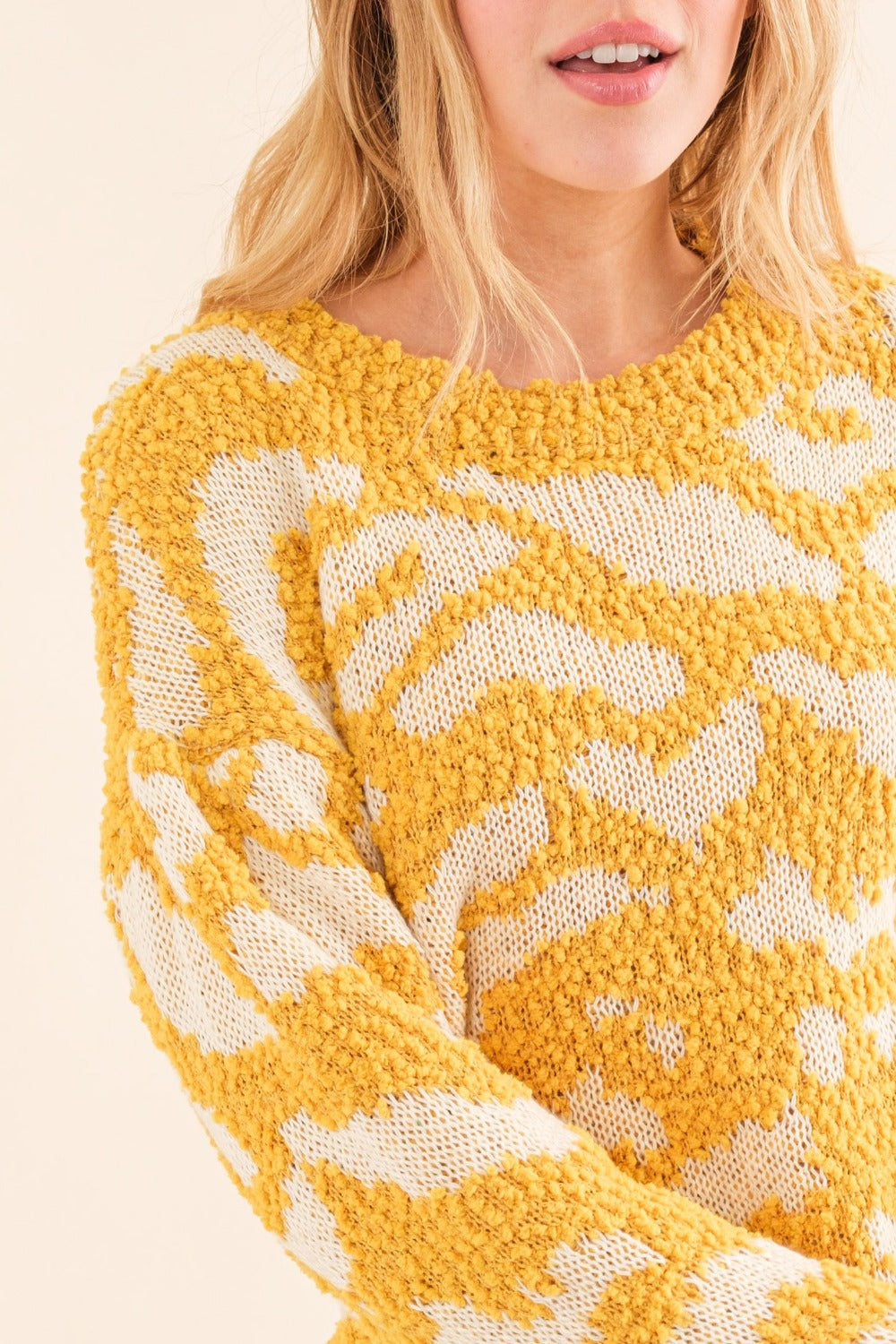 Close-up of yellow textured pattern sweater with white contrast
