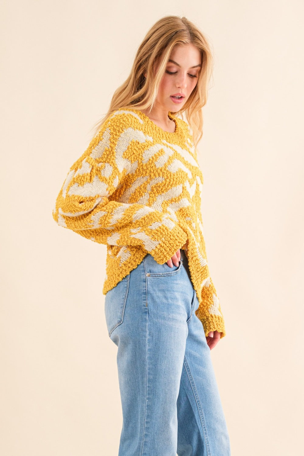Yellow textured pattern sweater with white contrast, side view