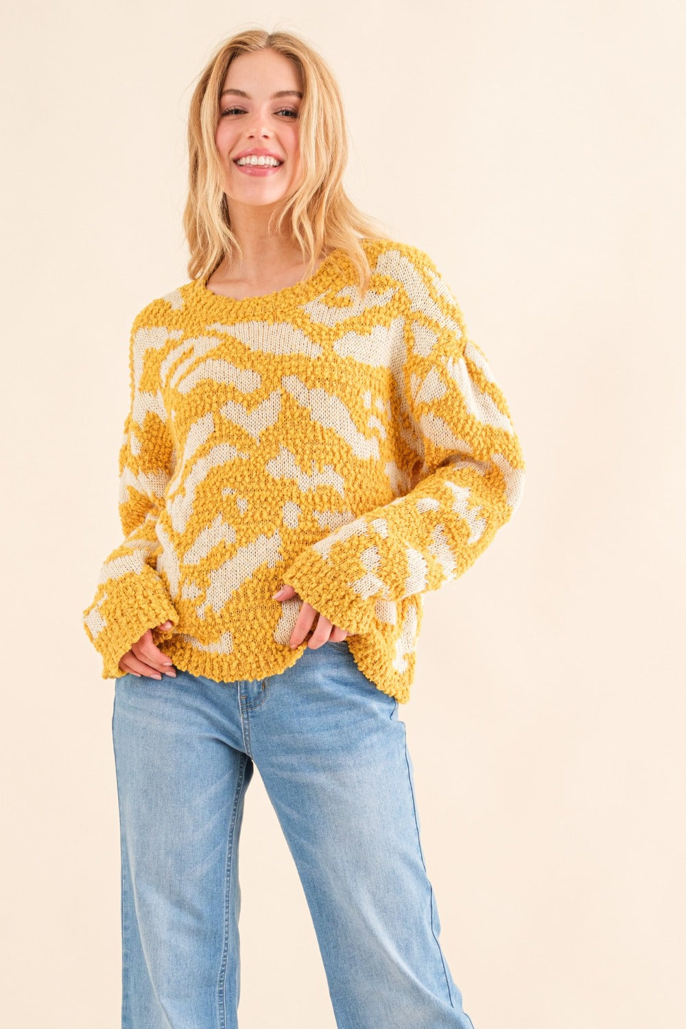 Yellow textured pattern sweater with white contrast, smiling model