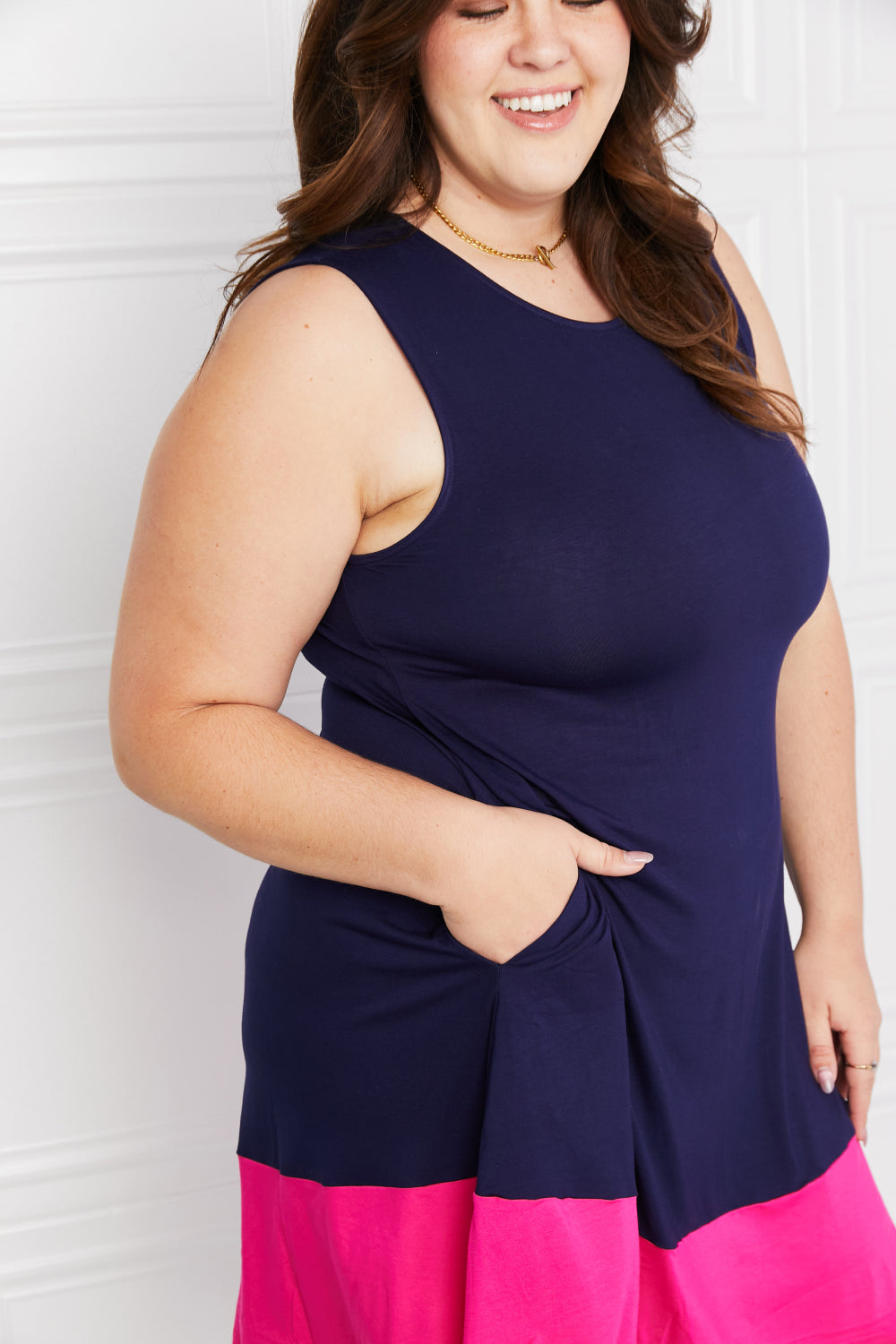Close-up of plus-size model with pocket detail on mini dress.