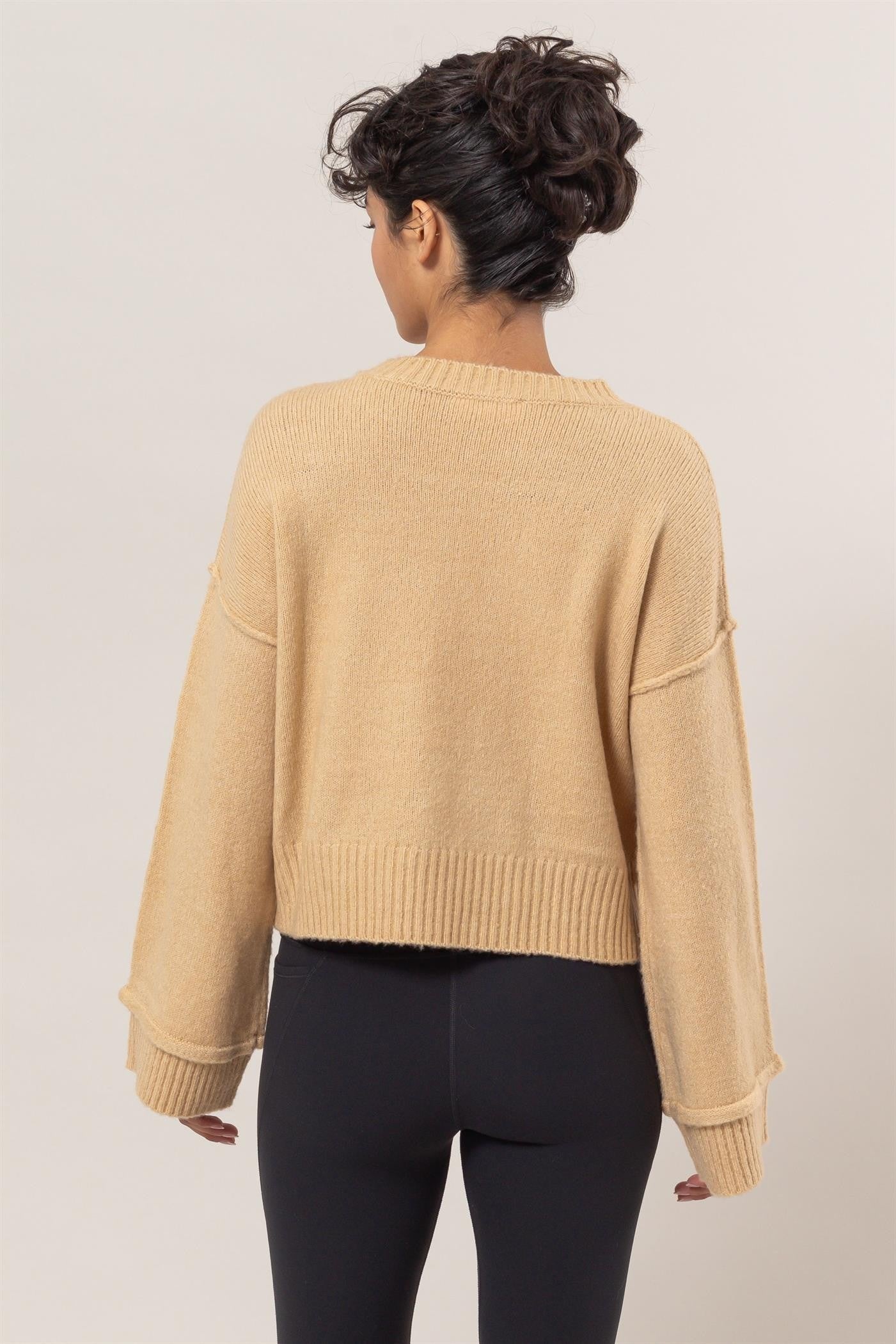 Beige ribbed sweater with crew neck, back view