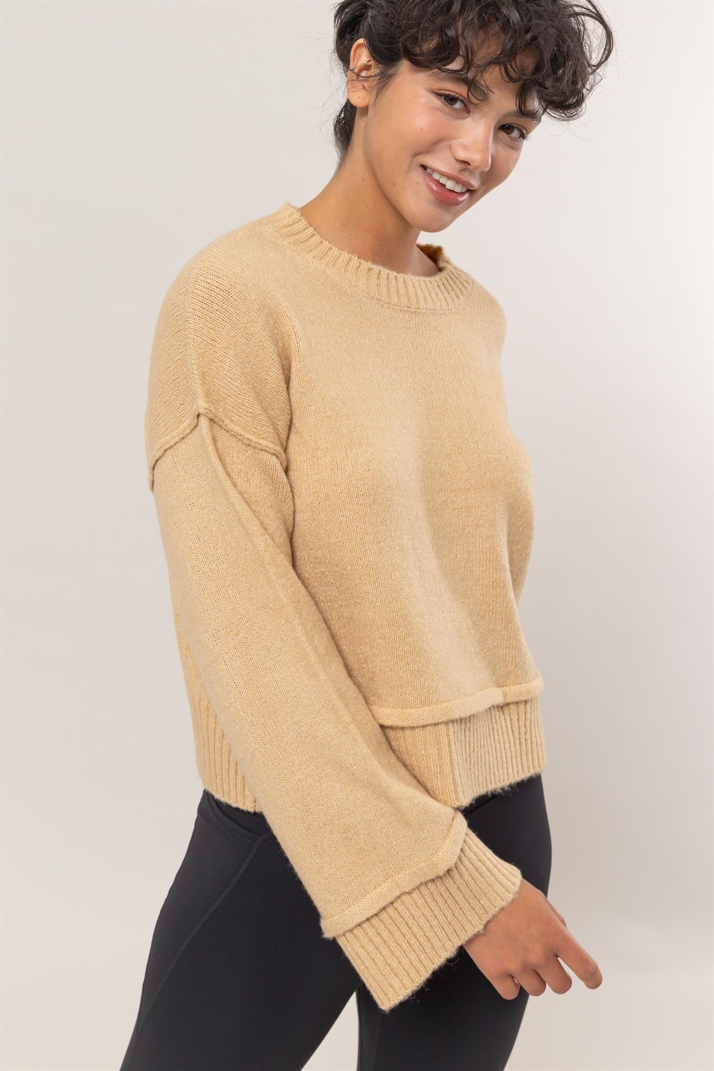 Beige ribbed sweater with crew neck, side view