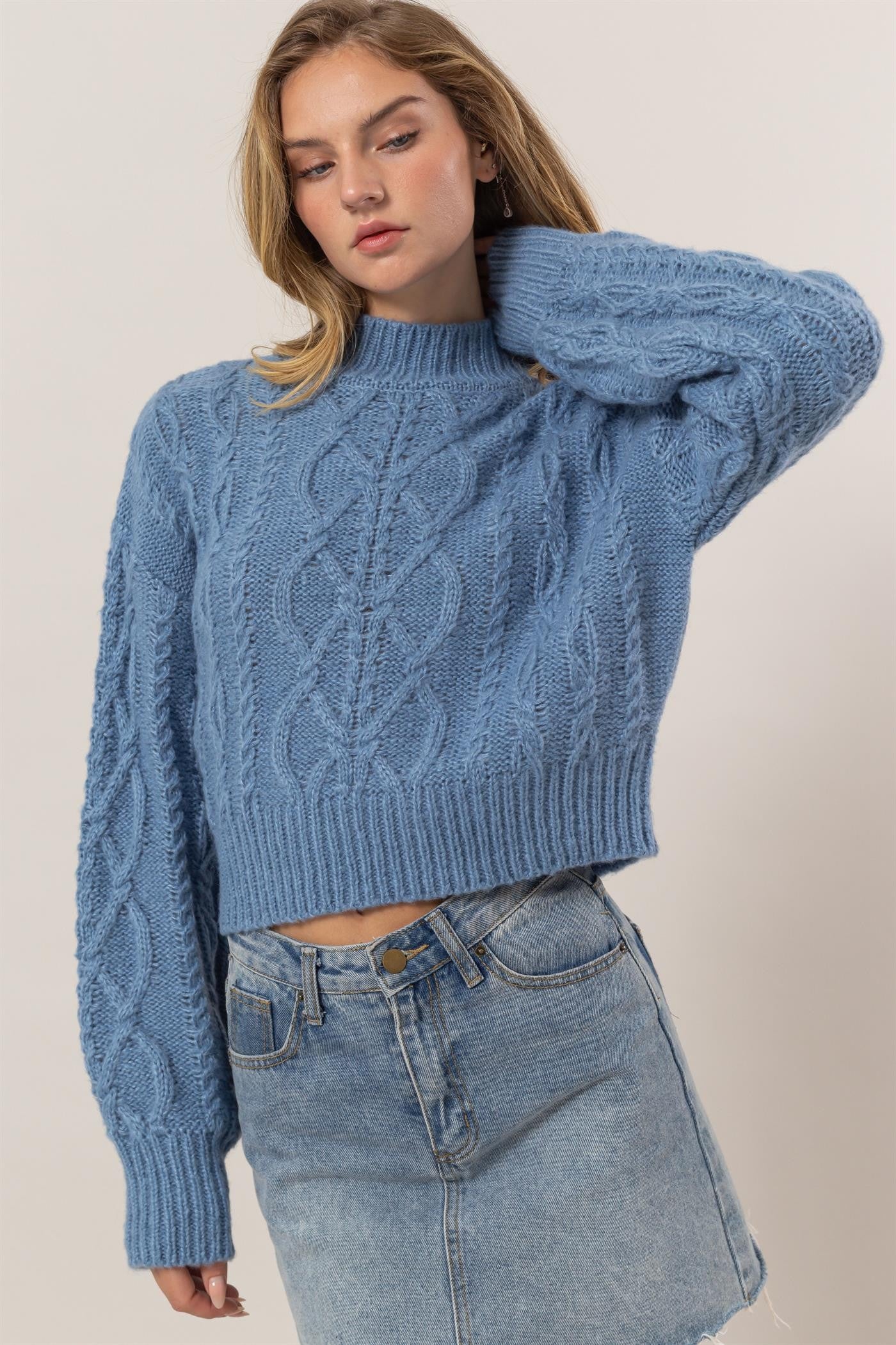 Blue Éclat Weave Mock Sweater with cable knit design.