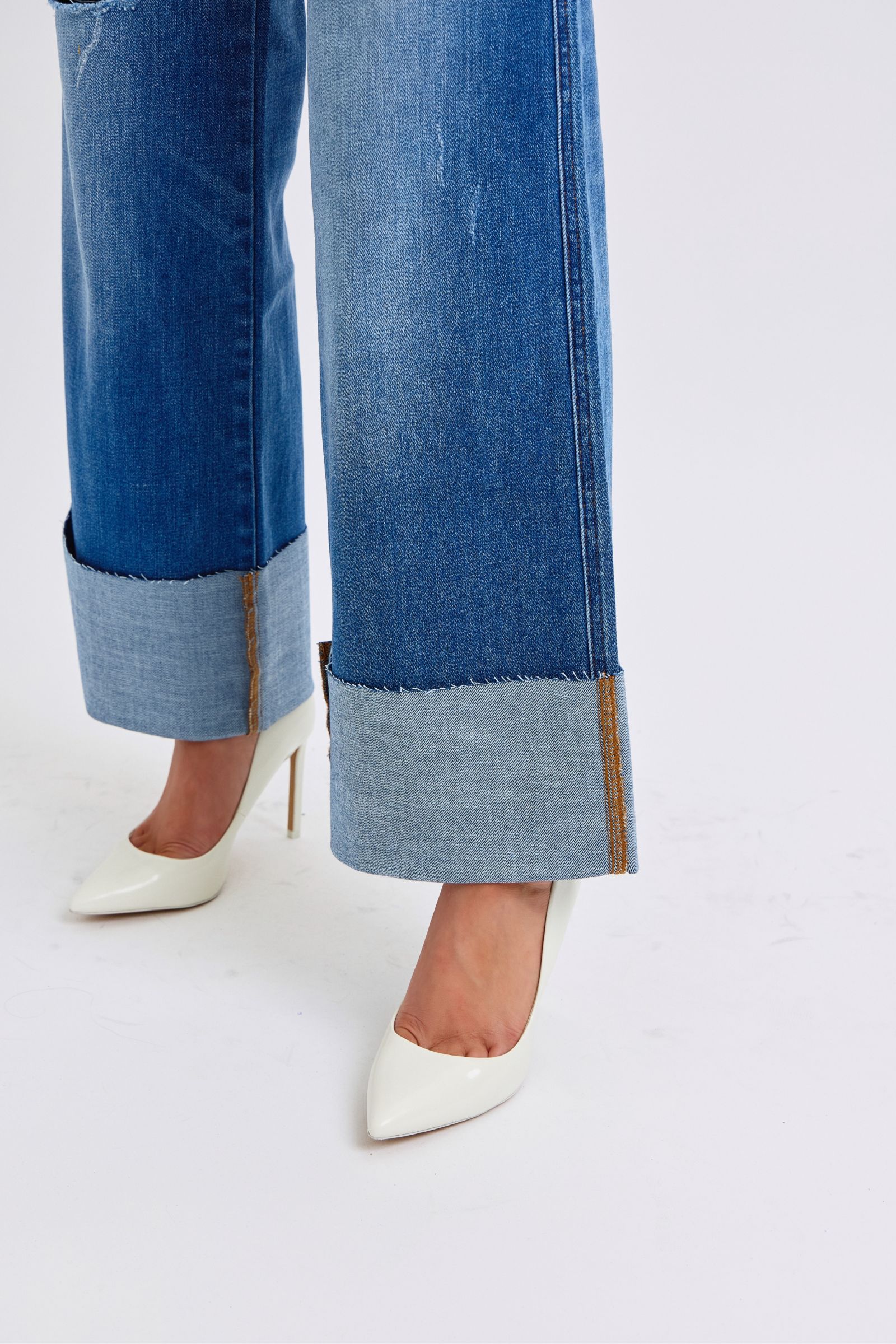 Close-up of cuffed hem on Elysian Distressed Wide-Leg Denim