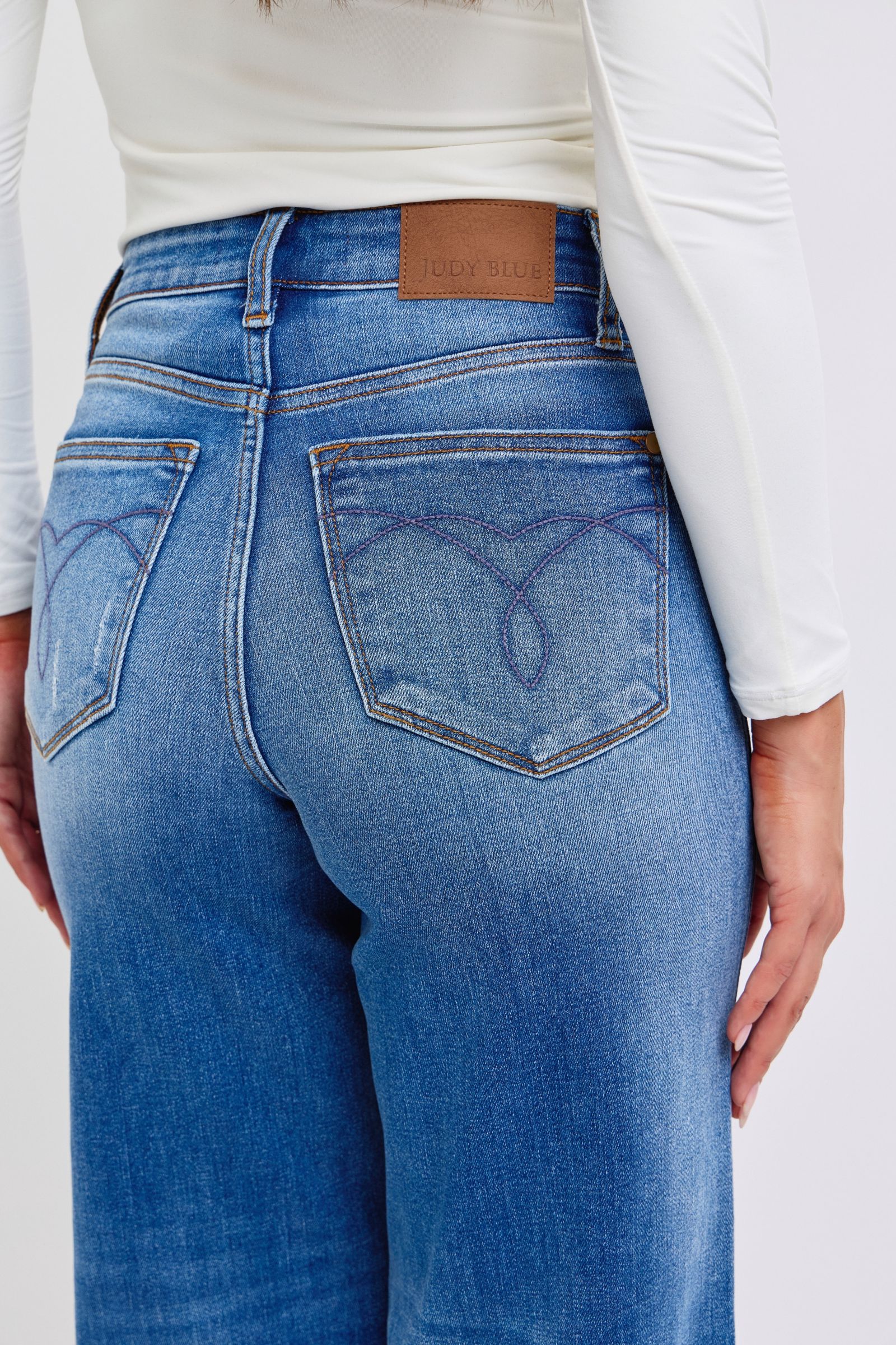 Close-up of back pocket on Elysian Distressed Wide-Leg Denim