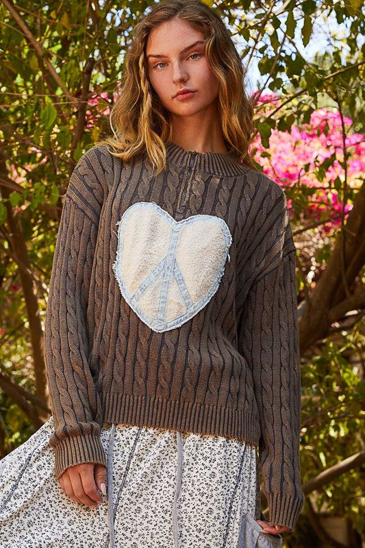 Stylish cable-knit sweater with peace patch detail