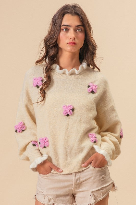 Ivory sweater with pink floral ruffles, front view