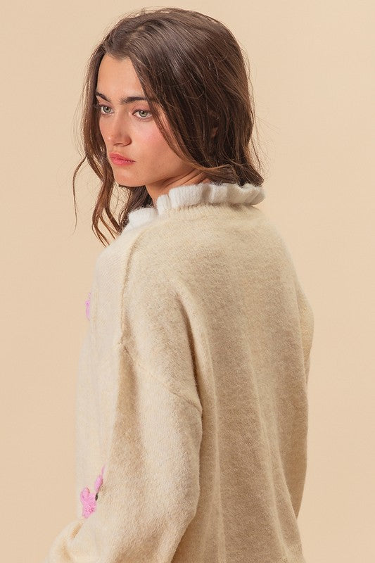 Side view of ivory sweater with ruffled collar