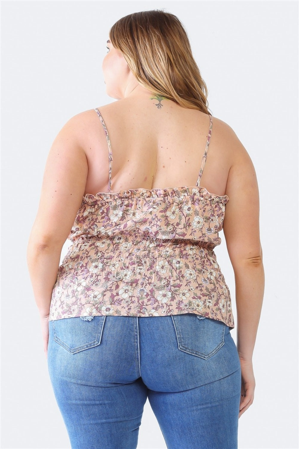 A person with long hair is wearing a floral strap top and blue jeans, viewed from the back against a plain background. The outfit features a stylish Plus Size Cami | Zenobia Frill Floral Square Neck that complements the overall look.