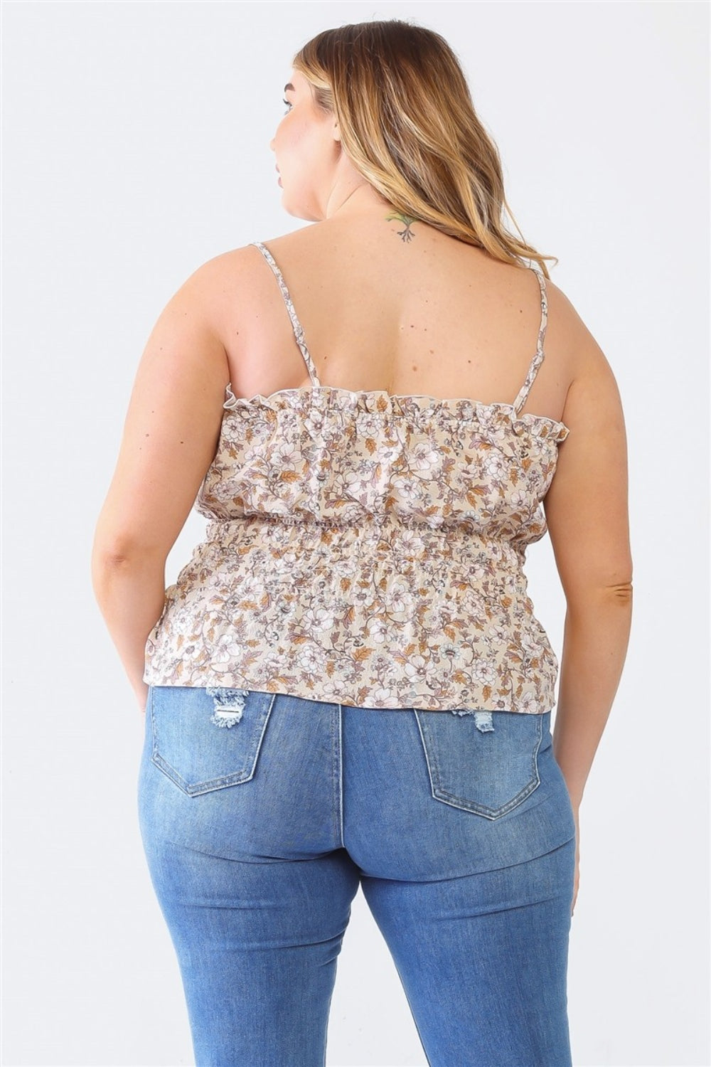 A person with long hair, wearing a floral sleeveless top and blue jeans, reminiscent of a Plus Size Cami | Zenobia Frill Floral Square Neck style, is facing away from the camera.