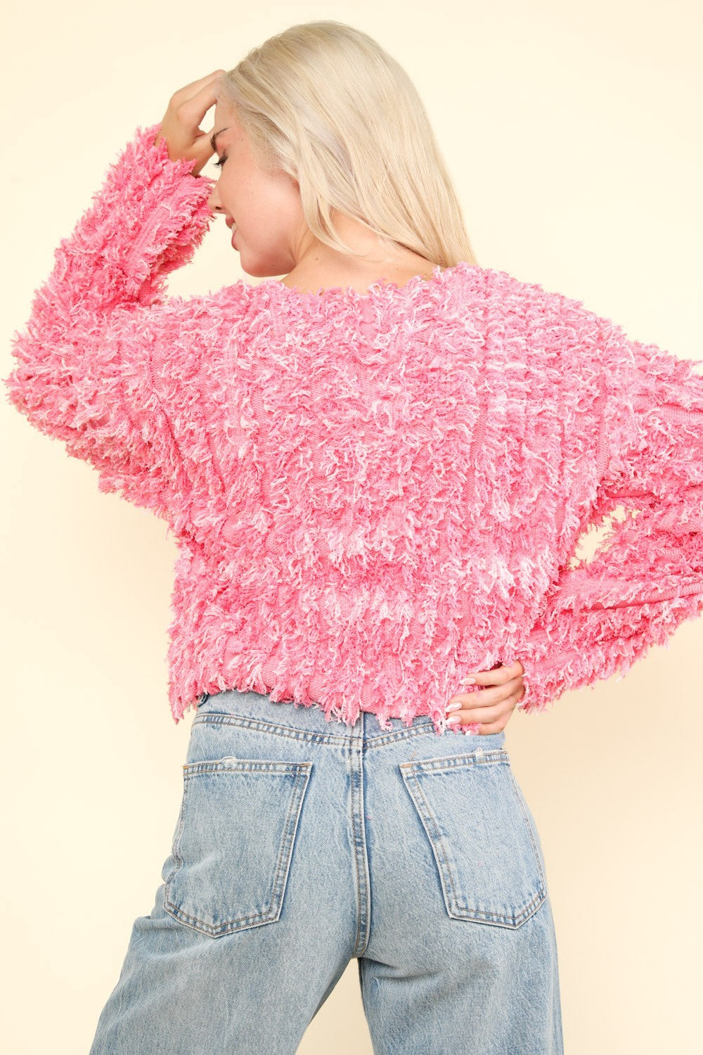 Back view of pink shaggy knit zip-up jacket.