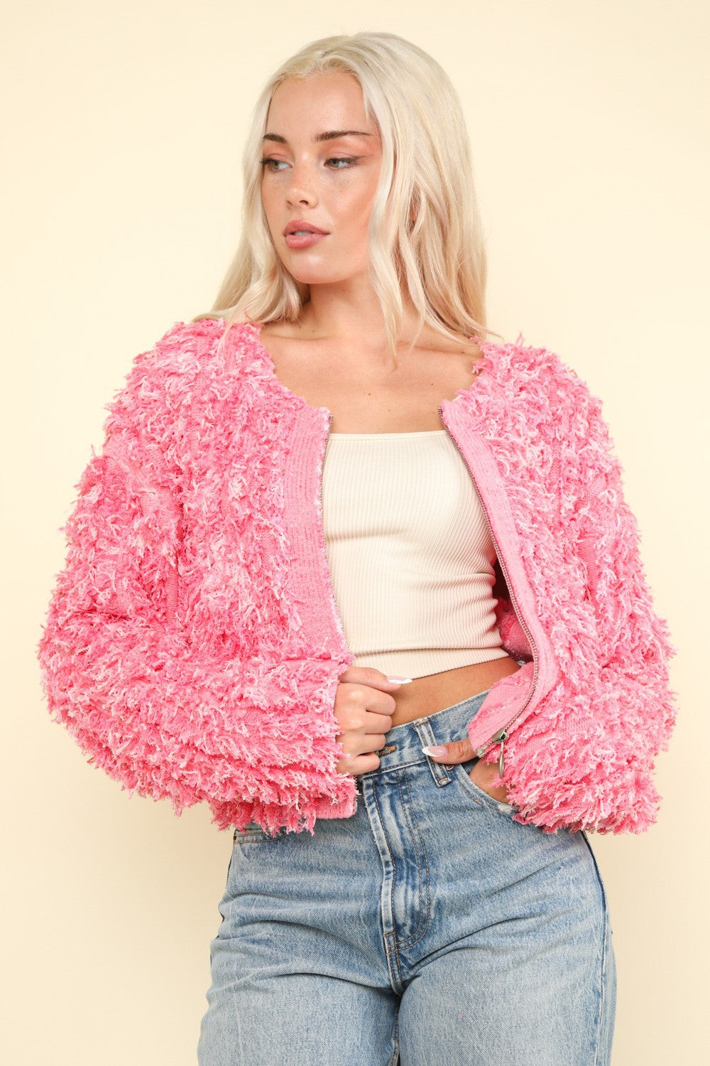 Front view of pink shaggy knit zip-up jacket.