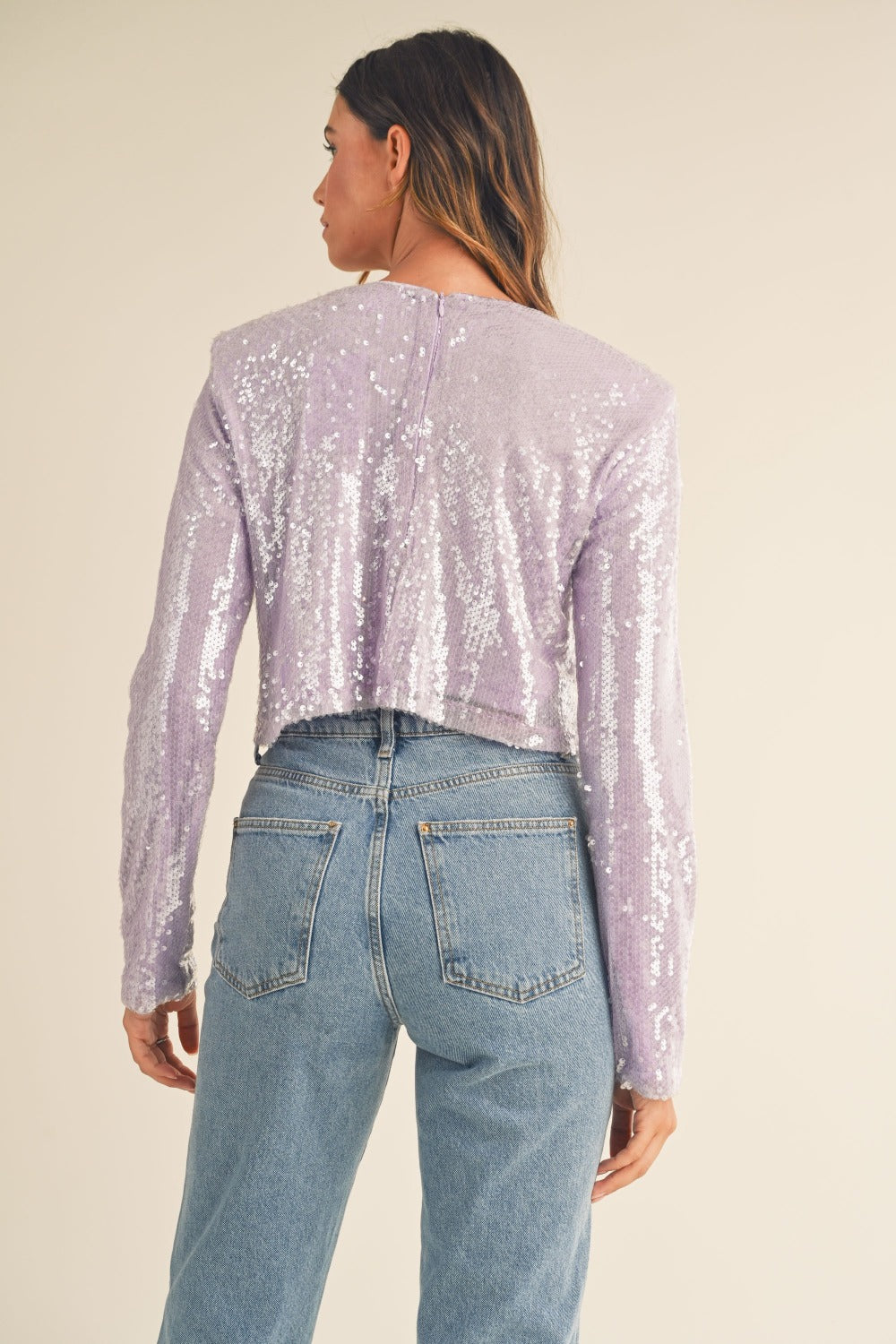 Back view of lavender sequin crop top with shoulder pads