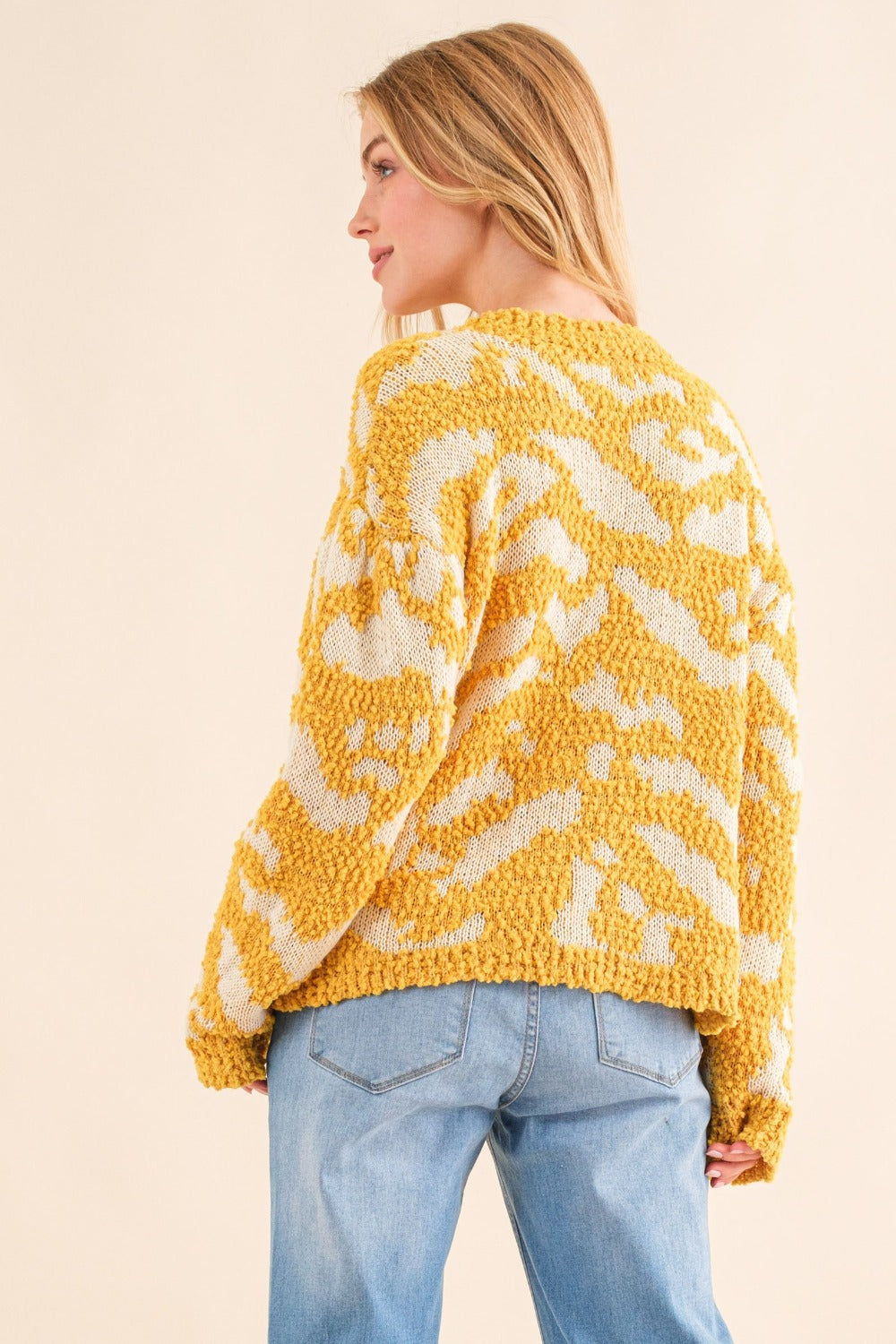 Yellow textured pattern sweater with white contrast, back view