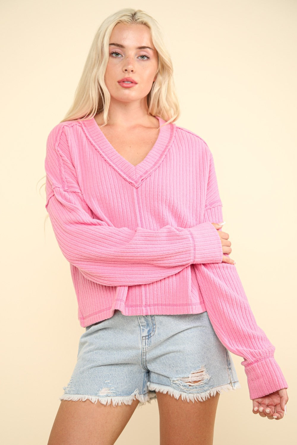 Pink V-neck ribbed knit top with exposed seams